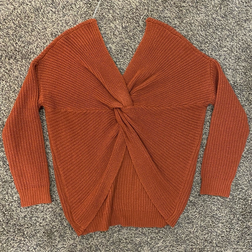 Burnt orange, twist back detail, v-neck, knit sweater. Can be off the shoulder.